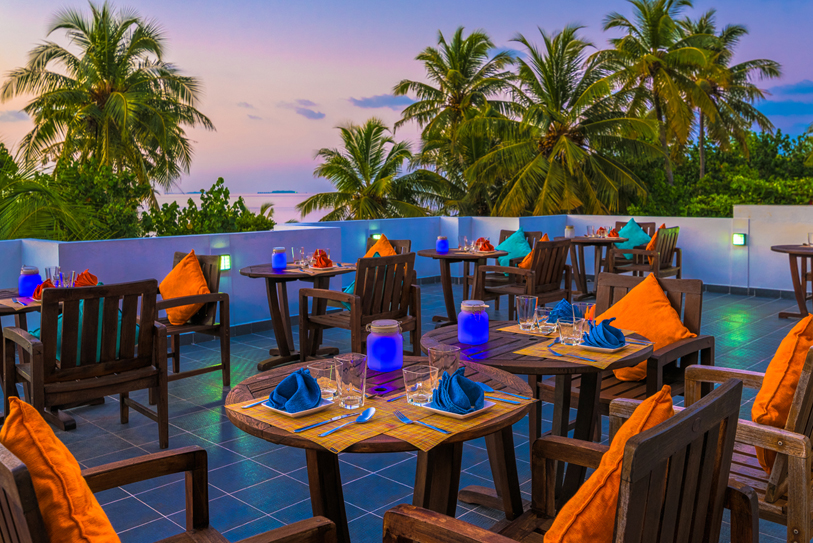 Boutique Beach Maldives Roof Terrace Restaurant with Tables laid in purple and orange