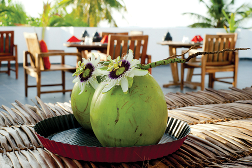 Boutique Beach Hotel  Welcome Drink Young Coconut with Passion Flower on Rood Terrace