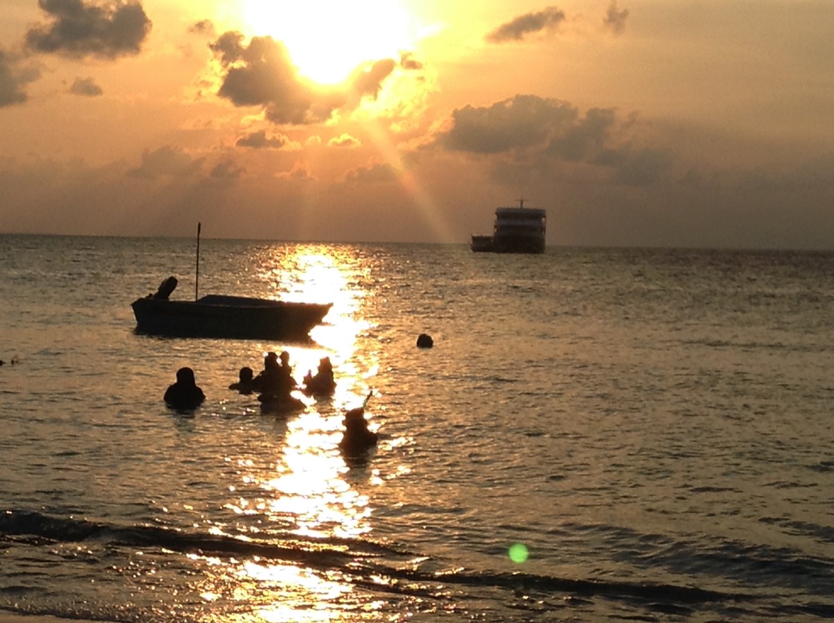 Boutique Beach Maldives Local People Swimming in the Ocean as the Sun Sets